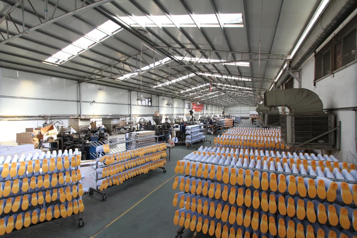 PVC boot production workshop with rows of finished boot pairs